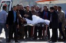 Former Egyptian President Hosni Mubarak waves to his supporters from his stretcher as he returns to Maadi military hospital in Cairo