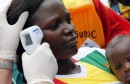 A health worker checks the temperature of a fan of Guinea at Malabo Stadium, ahead of their Group D soccer match against Ivory Coast in the African Cup of Nations, in Malabo