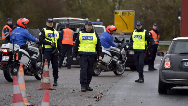 Belgian and French police officers provide security as they control the crossing of vehicles on the border between the two countries, following the deadly Paris attacks, in Crespin