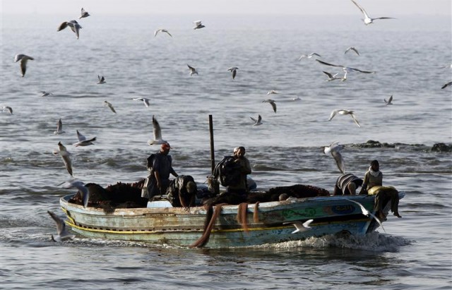 Fishermen work from their boat in Alexandria