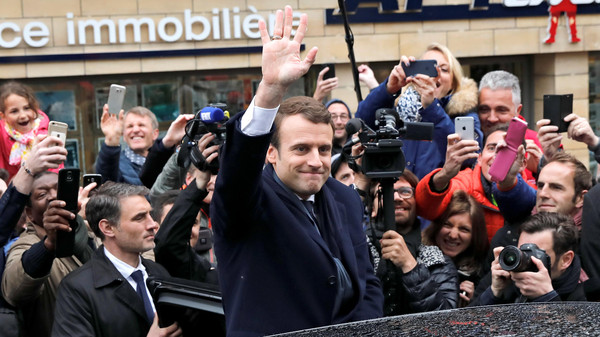 French presidential election candidate Emmanuel Macron, head of the political movement En Marche !, or Onwards ! greets supporters as leaves his residence during the the second round of 2017 French presidential election, in Le Touquet