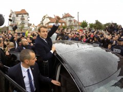 French presidential election candidate Emmanuel Macron greets supporters as he leaves a polling station during the the second round of 2017 French presidential election, in Le Touquet