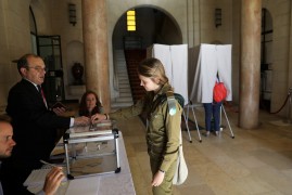 A French national living in Israel casts her vote in the second round of the 2017 French presidential election, at a polling station in Jerusalem